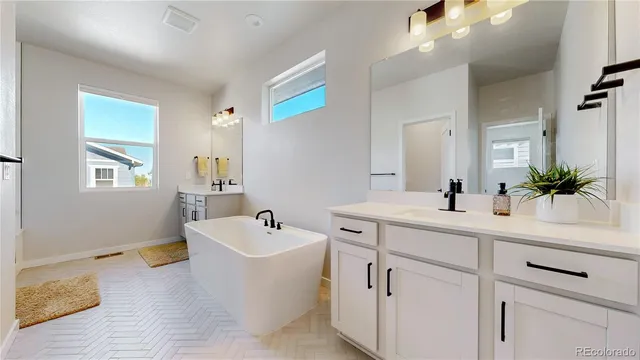 a spacious bathroom with sink double vanity and mirror