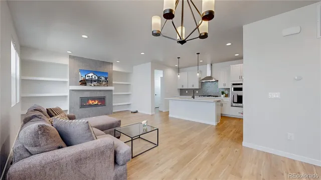 a living room with furniture and kitchen view