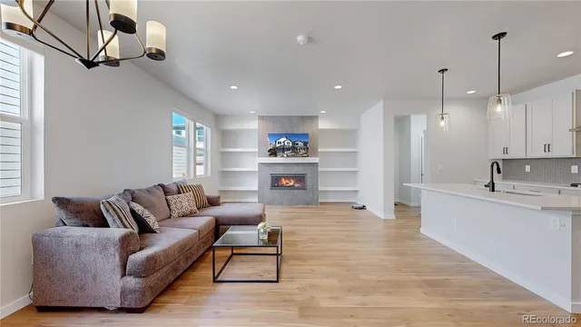 a living room with furniture and a wooden floor