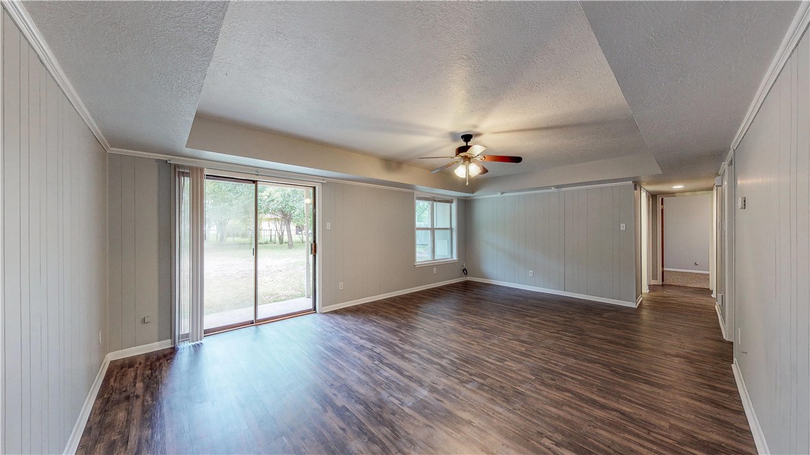 1108 Forest Glen Court Bryan, TX 77803 - Photo 11 of 26 a view of an empty room with wooden floor and a window