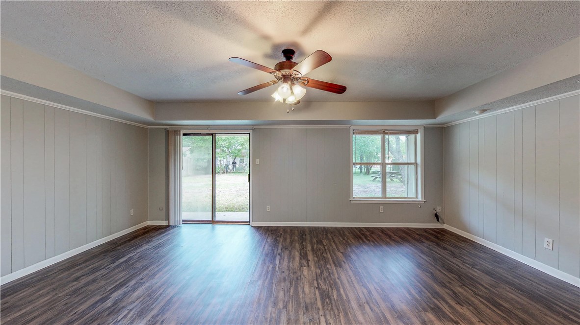 1108 Forest Glen Court Bryan, TX 77803 - Photo 12 of 26 a view of an empty room with wooden floor and a window