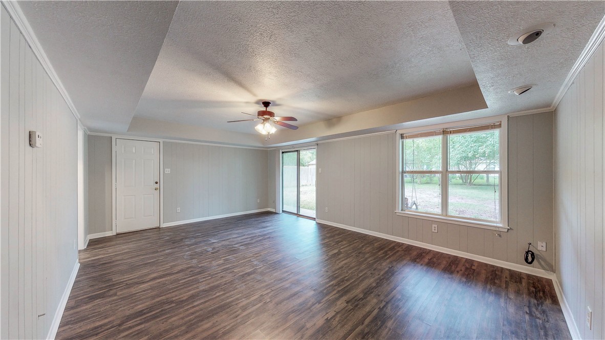 1108 Forest Glen Court Bryan, TX 77803 - Photo 14 of 26 a view of an empty room with wooden floor and a window