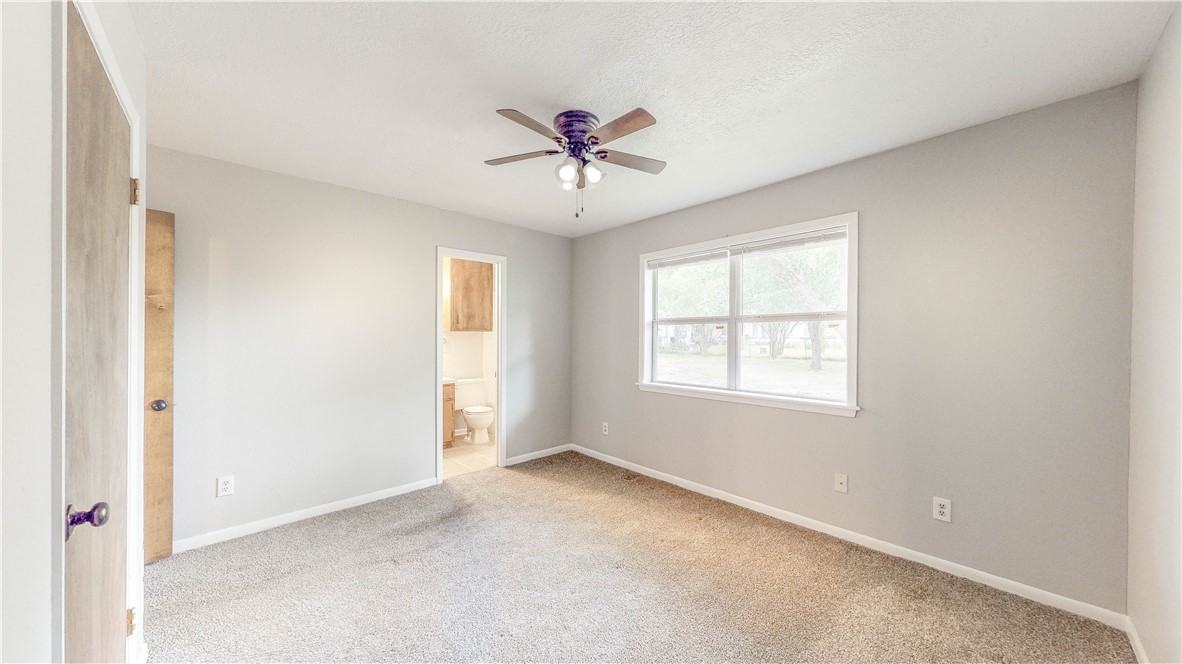 1108 Forest Glen Court Bryan, TX 77803 - Photo 17 of 26 a view of a livingroom with a ceiling fan and window