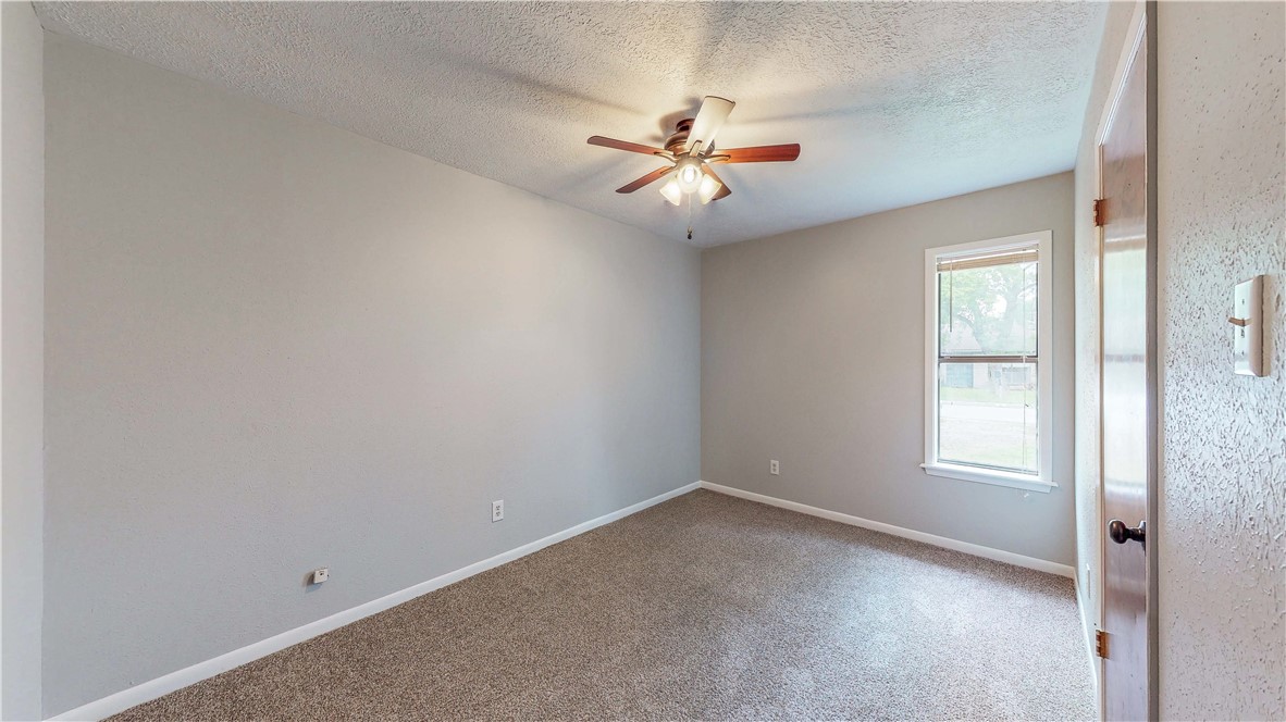 1108 Forest Glen Court Bryan, TX 77803 - Photo 22 of 26 an empty room with windows and fan