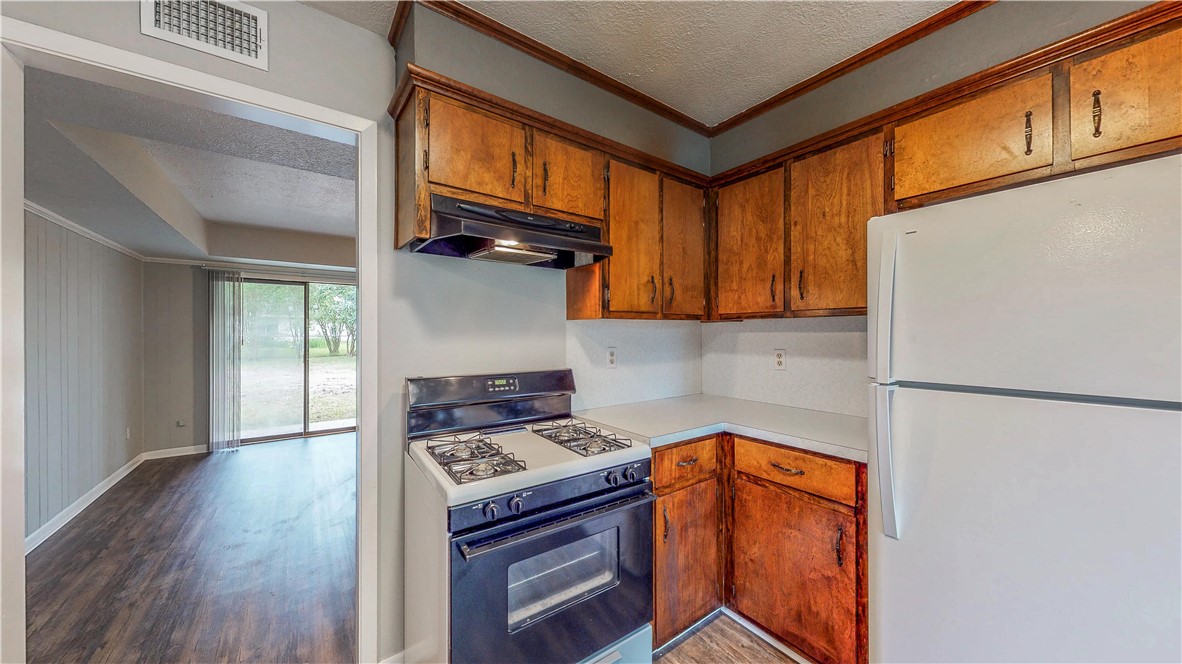 1108 Forest Glen Court Bryan, TX 77803 - Photo 5 of 26 a kitchen with stainless steel appliances granite countertop a stove a refrigerator and a cabinets