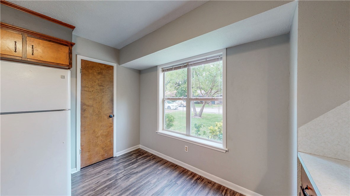1108 Forest Glen Court Bryan, TX 77803 - Photo 10 of 26 a view of an empty room with window and wooden floor