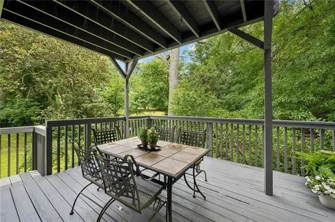 a view of a balcony with wooden floor and outdoor seating