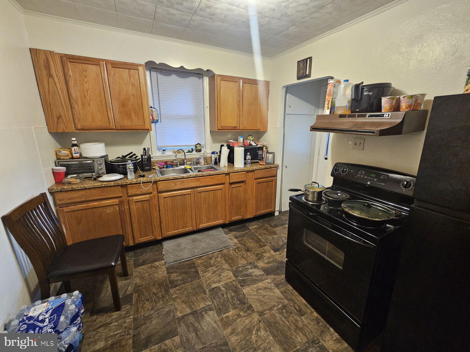 1007 East Prospect Street York, PA 17403 - Photo 4 of 5 a kitchen with a stove a sink and wooden floor