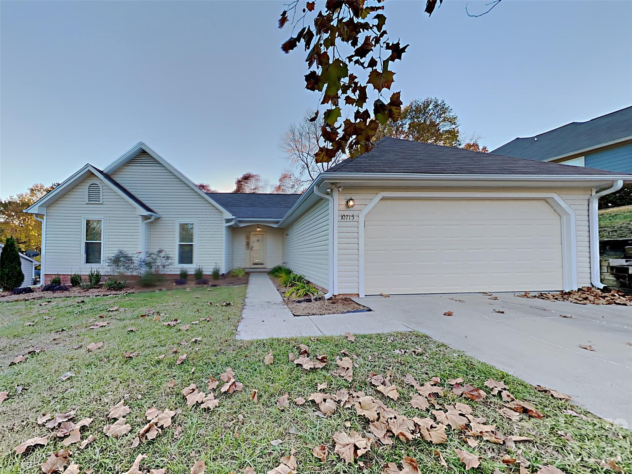 10715 Spruce Mountain Road Charlotte, NC 28214 - Photo 1 of 26 a front view of a house with a yard and garage