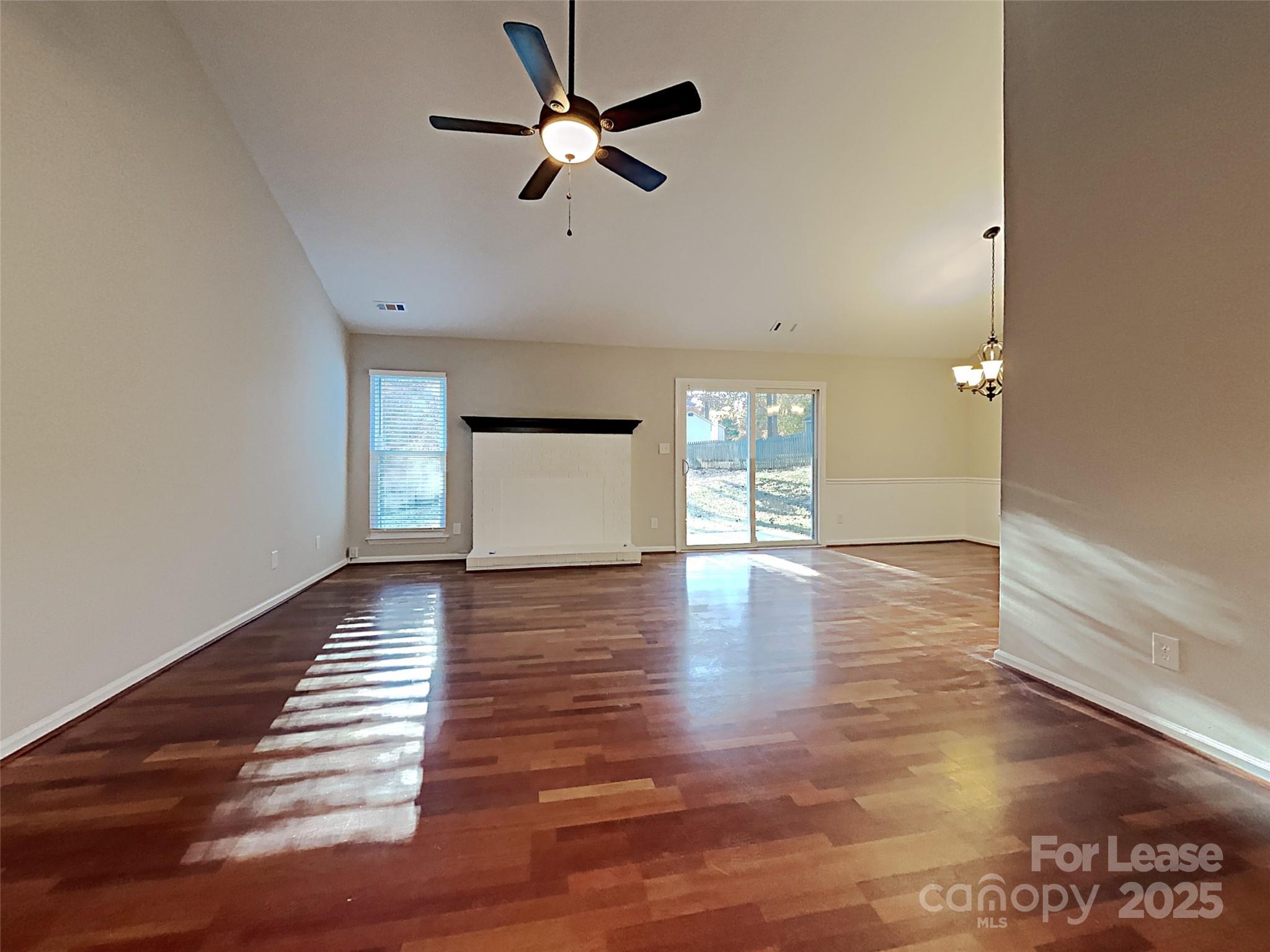 10715 Spruce Mountain Road Charlotte, NC 28214 - Photo 14 of 26 a view of empty room with wooden floor and fan