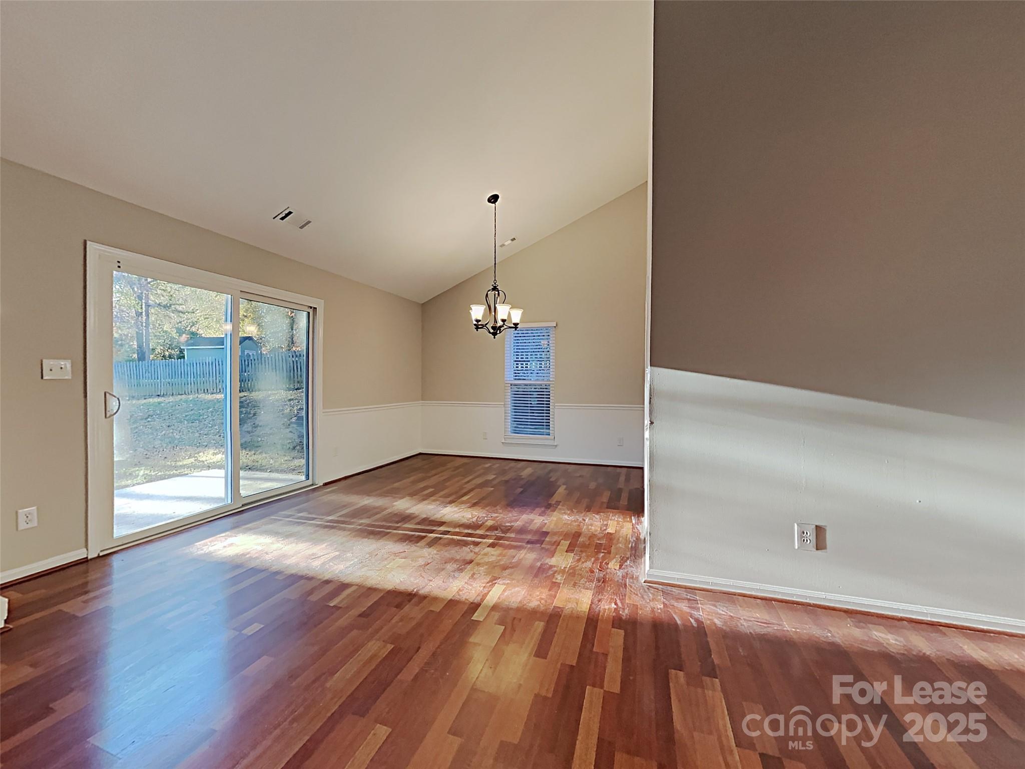 10715 Spruce Mountain Road Charlotte, NC 28214 - Photo 15 of 26 a view of empty room with wooden floor and fan