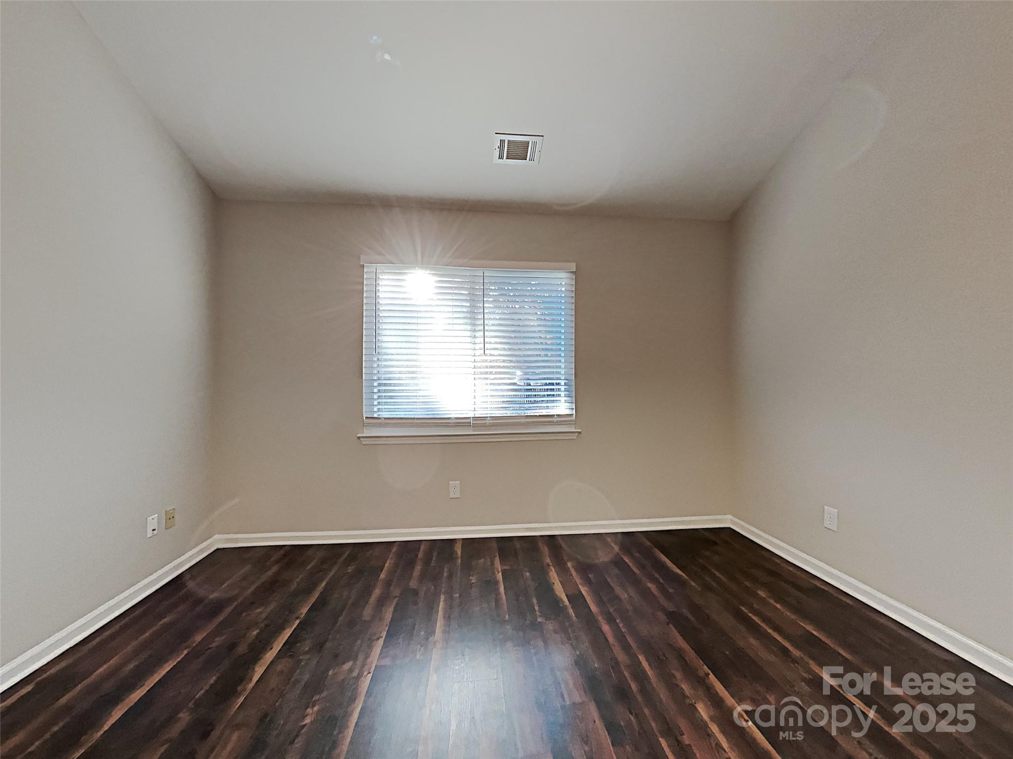 10715 Spruce Mountain Road Charlotte, NC 28214 - Photo 18 of 26 a view of a room with wooden floor and window