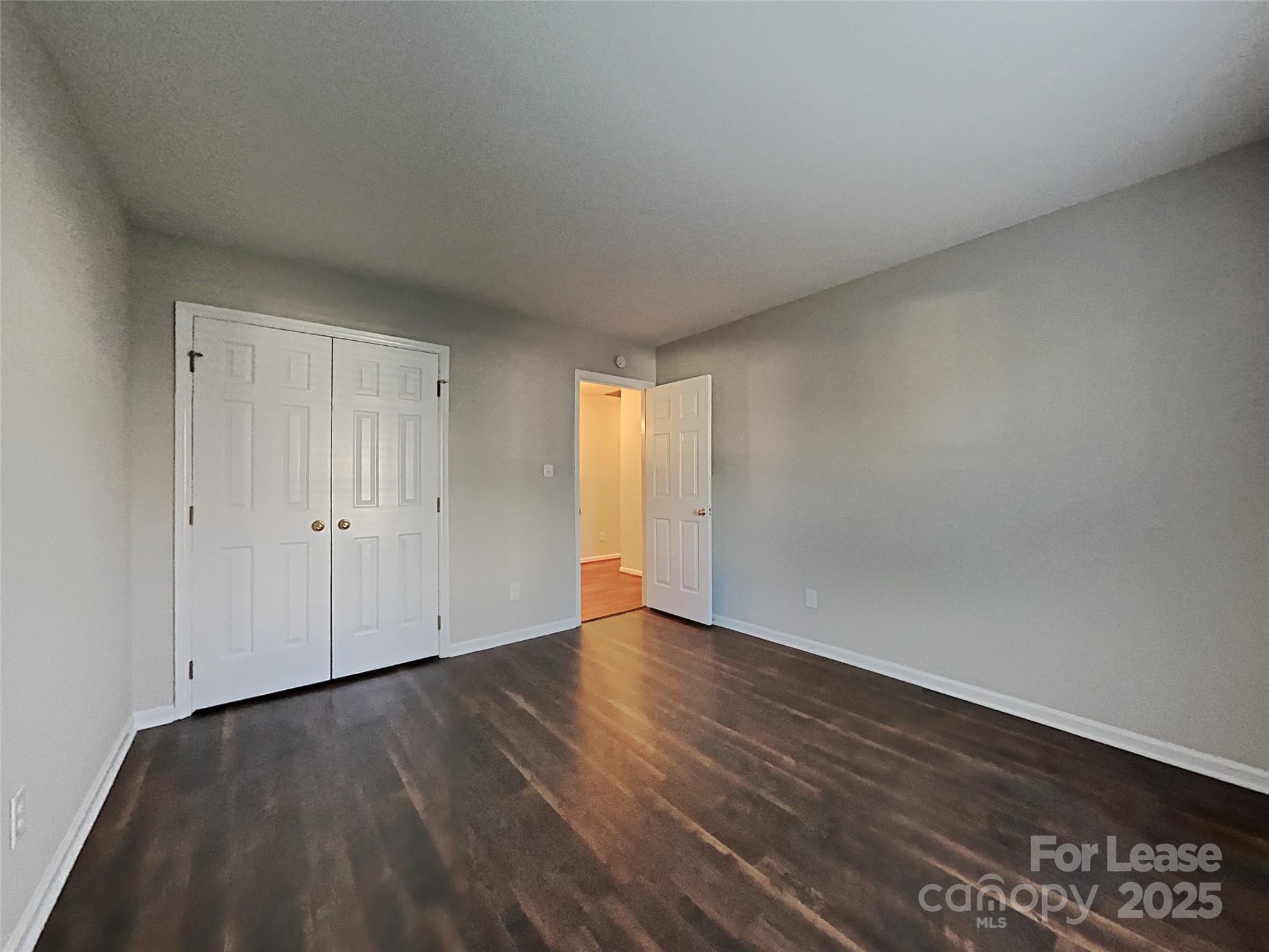 10715 Spruce Mountain Road Charlotte, NC 28214 - Photo 19 of 26 a view of an empty room with wooden floor and a window