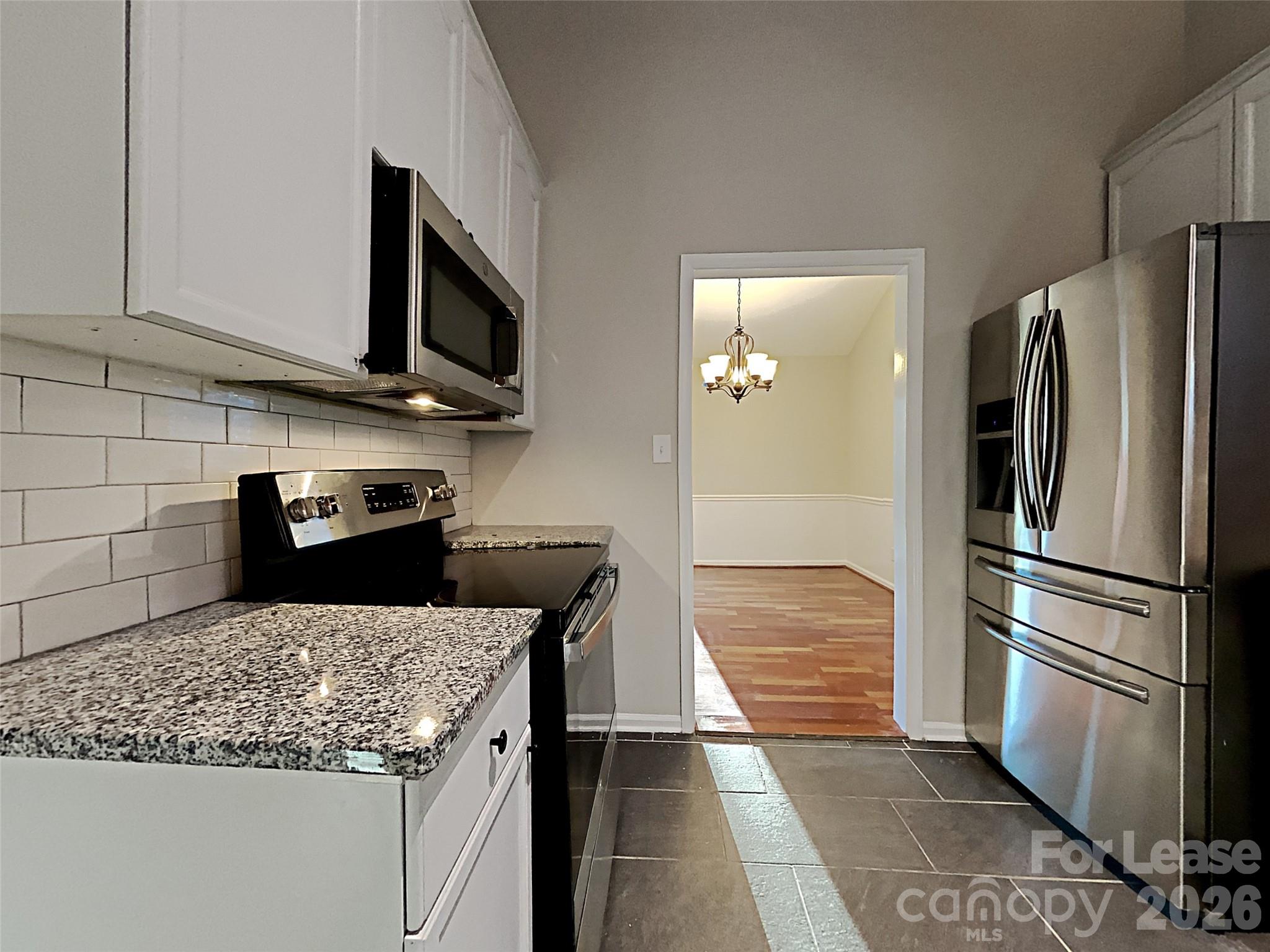 10715 Spruce Mountain Road Charlotte, NC 28214 - Photo 2 of 26 a kitchen with stainless steel appliances granite countertop a refrigerator stove and microwave