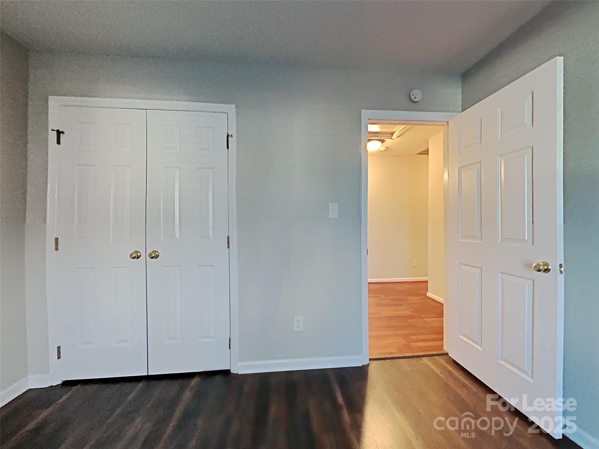 10715 Spruce Mountain Road Charlotte, NC 28214 - Photo 23 of 26 a view of an empty room with wooden floor