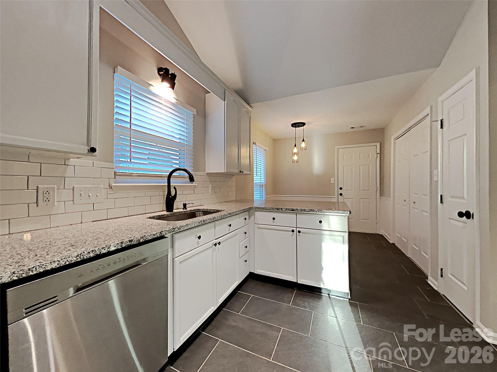 10715 Spruce Mountain Road Charlotte, NC 28214 - Photo 6 of 26 a spacious bathroom with a granite countertop sink and a mirror