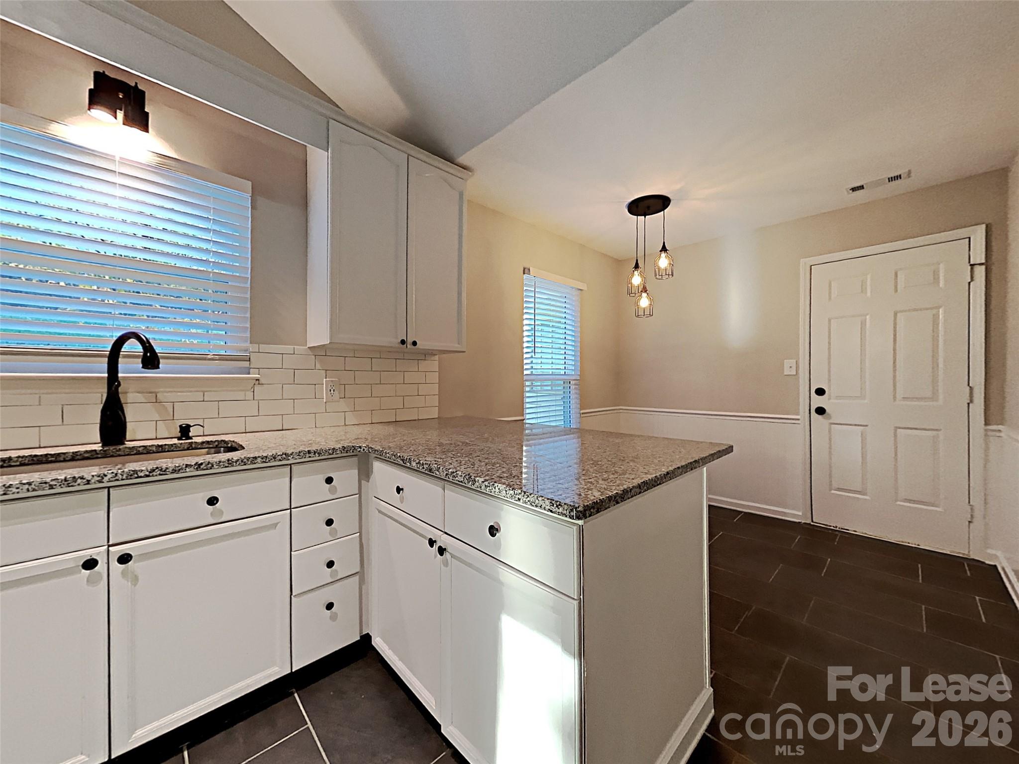 10715 Spruce Mountain Road Charlotte, NC 28214 - Photo 8 of 26 a kitchen with a sink and cabinets