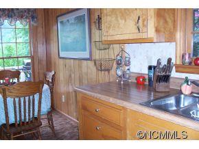 477 Rocky Top Road Maggie Valley, NC 28751 - Photo 11 of 20 a bathroom with a sink a mirror and a window