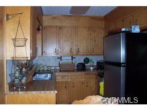 477 Rocky Top Road Maggie Valley, NC 28751 - Photo 12 of 20 a kitchen with a refrigerator and a stove