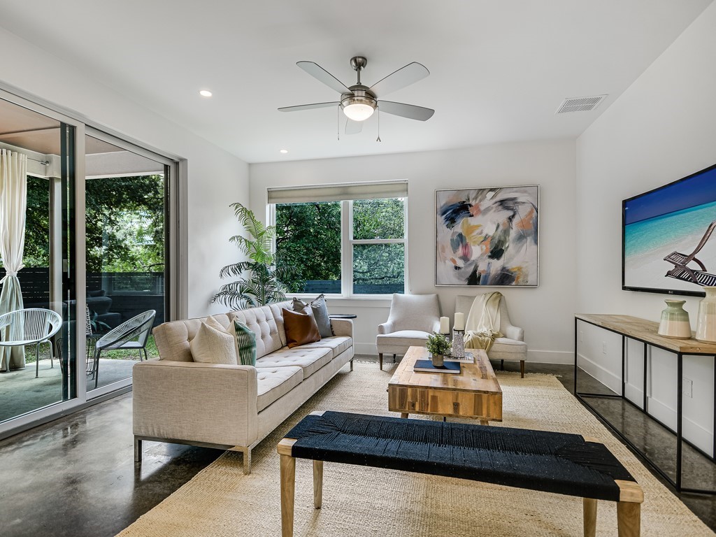 a living room with furniture and a large window