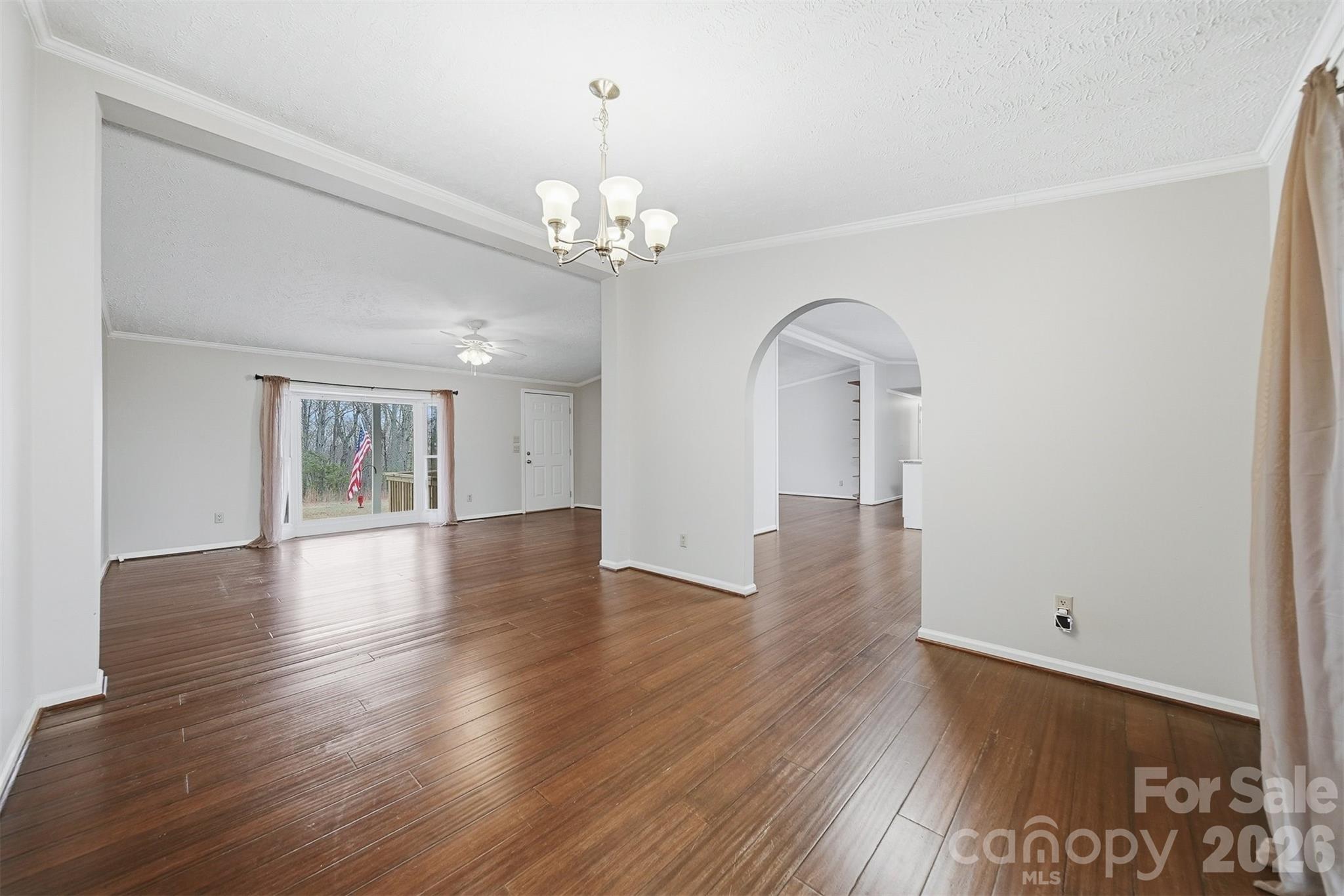 4915 Quartz Ridge Road Maiden, NC 28650 - Photo 12 of 38 a view of an empty room with wooden floor and a window
