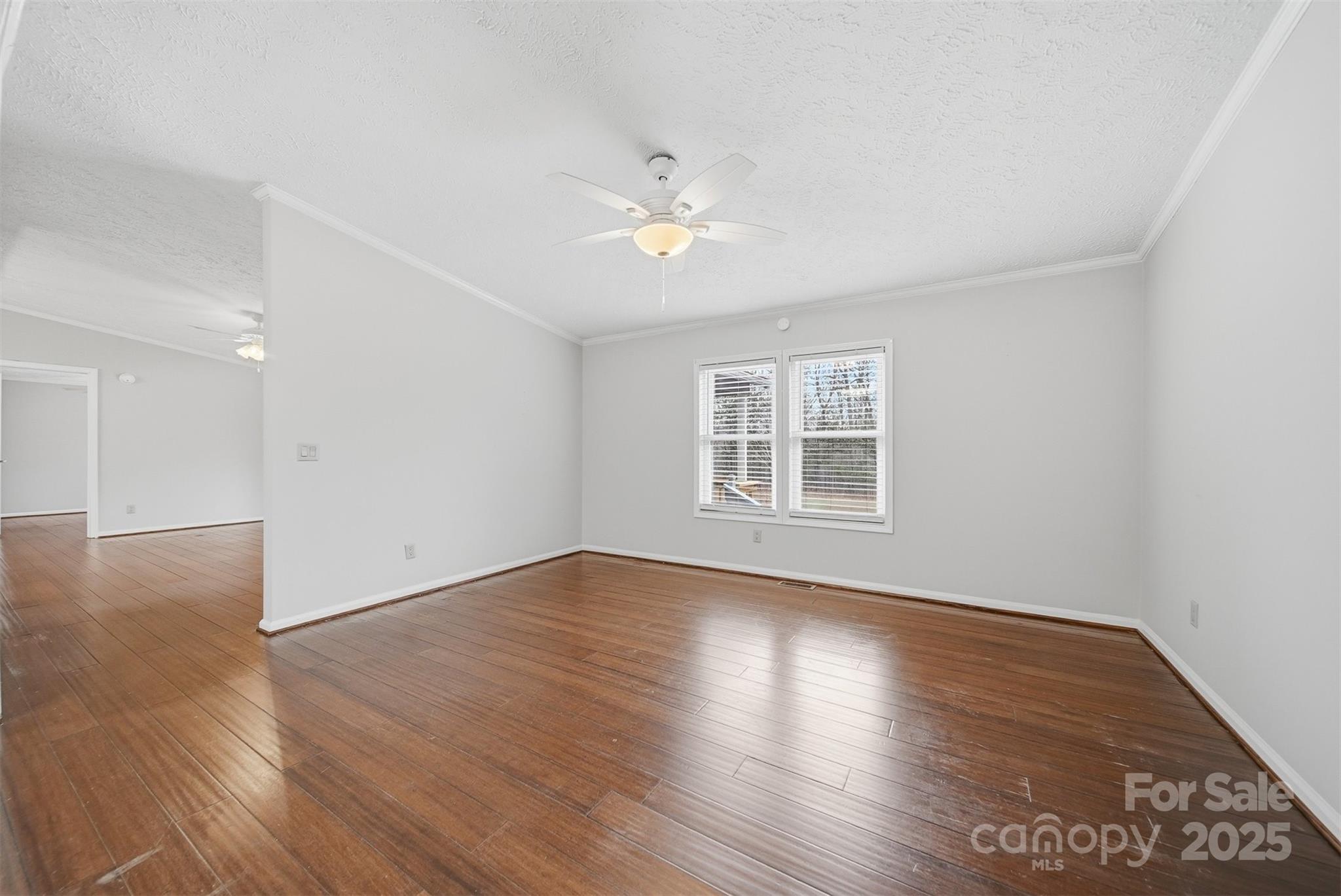 4915 Quartz Ridge Road Maiden, NC 28650 - Photo 14 of 38 a view of empty room with wooden floor and fan