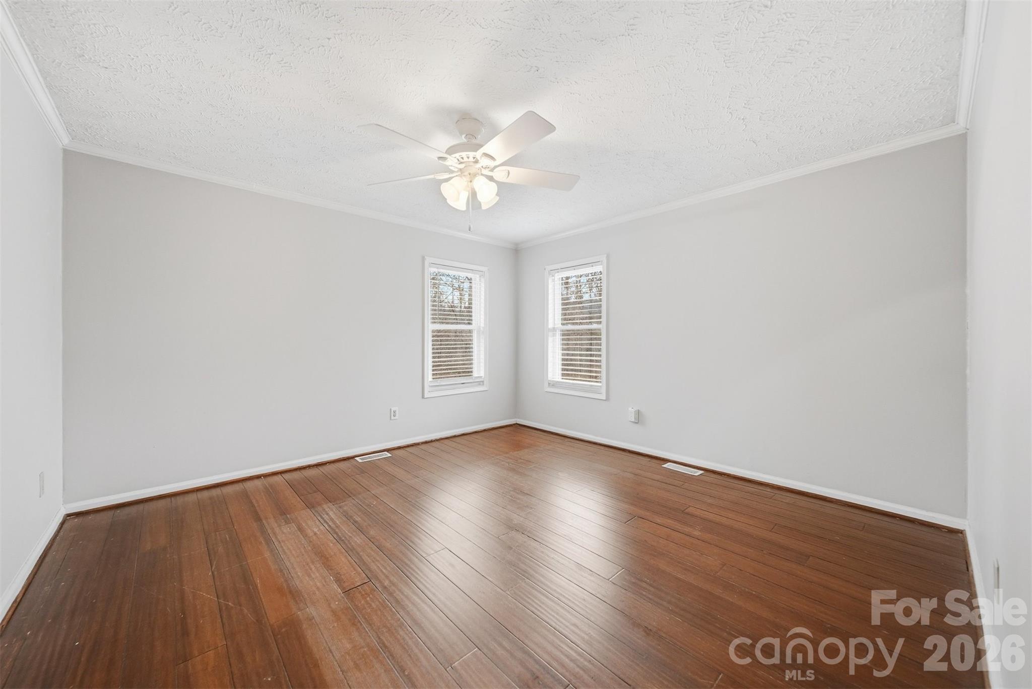 4915 Quartz Ridge Road Maiden, NC 28650 - Photo 16 of 38 an empty room with wooden floor and windows