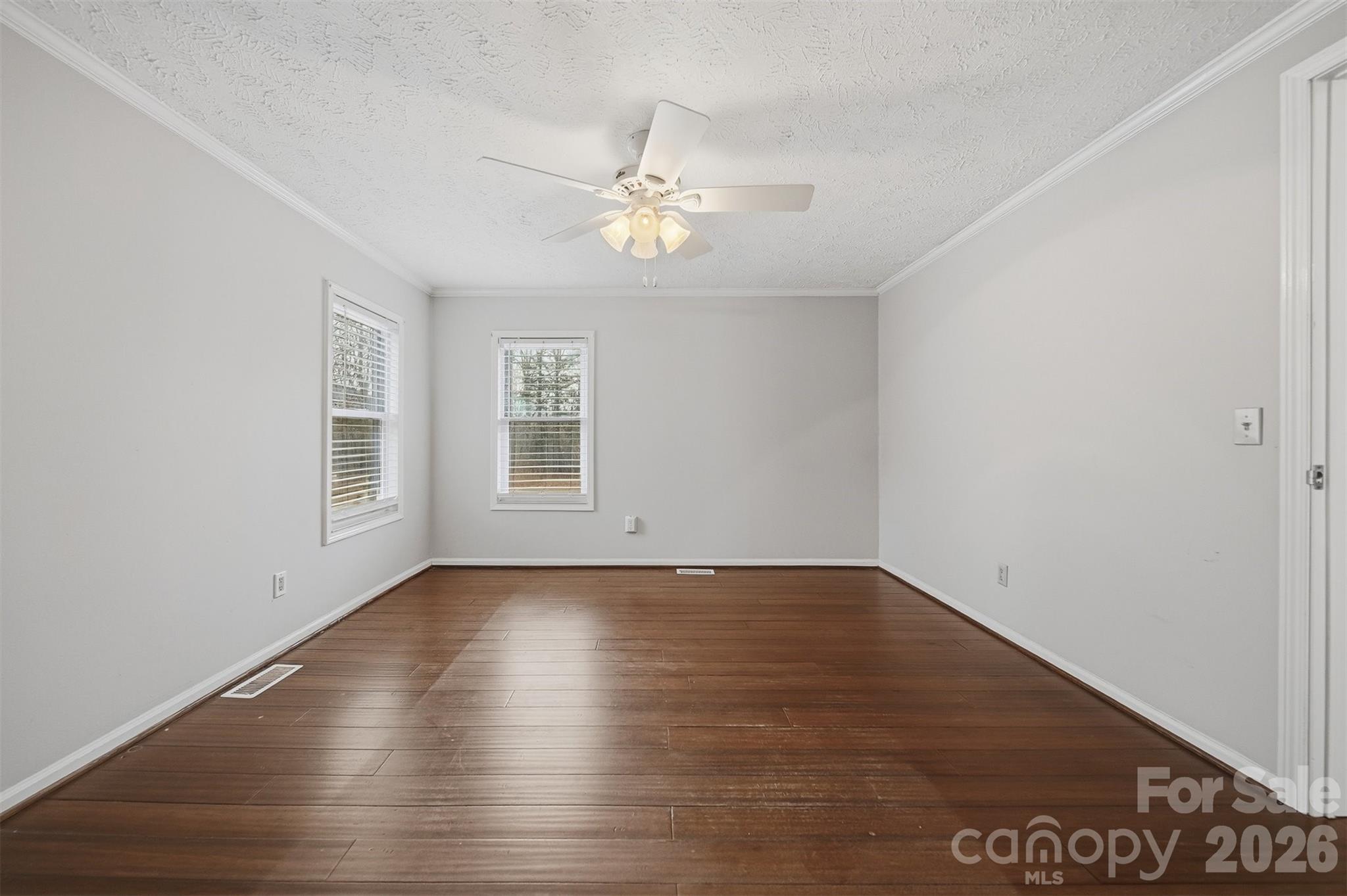 4915 Quartz Ridge Road Maiden, NC 28650 - Photo 16 of 38 a view of an empty room with wooden floor and a window