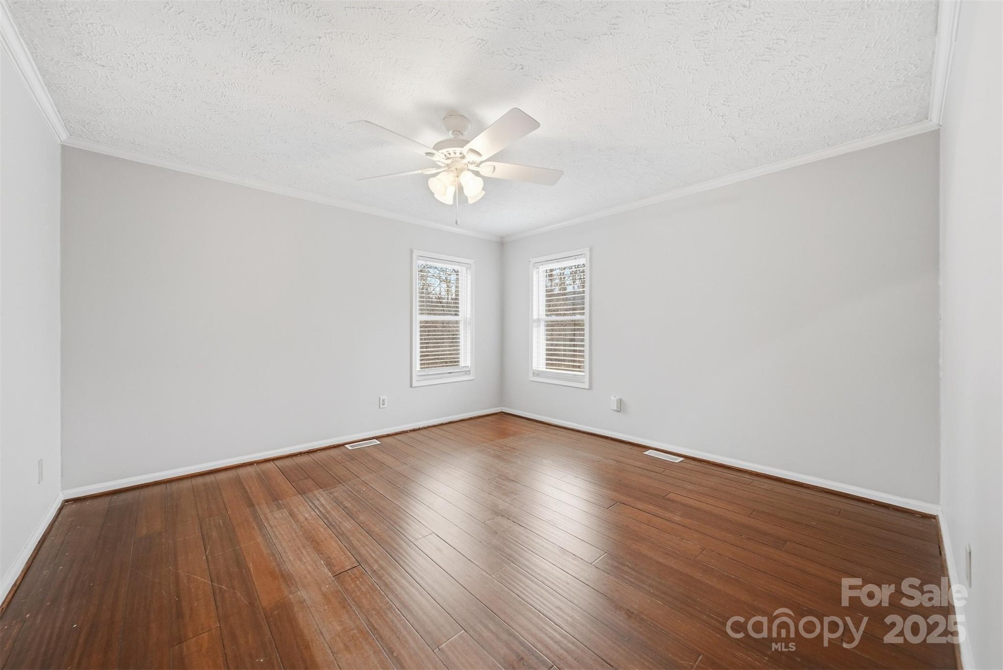 4915 Quartz Ridge Road Maiden, NC 28650 - Photo 16 of 38 an empty room with wooden floor and windows