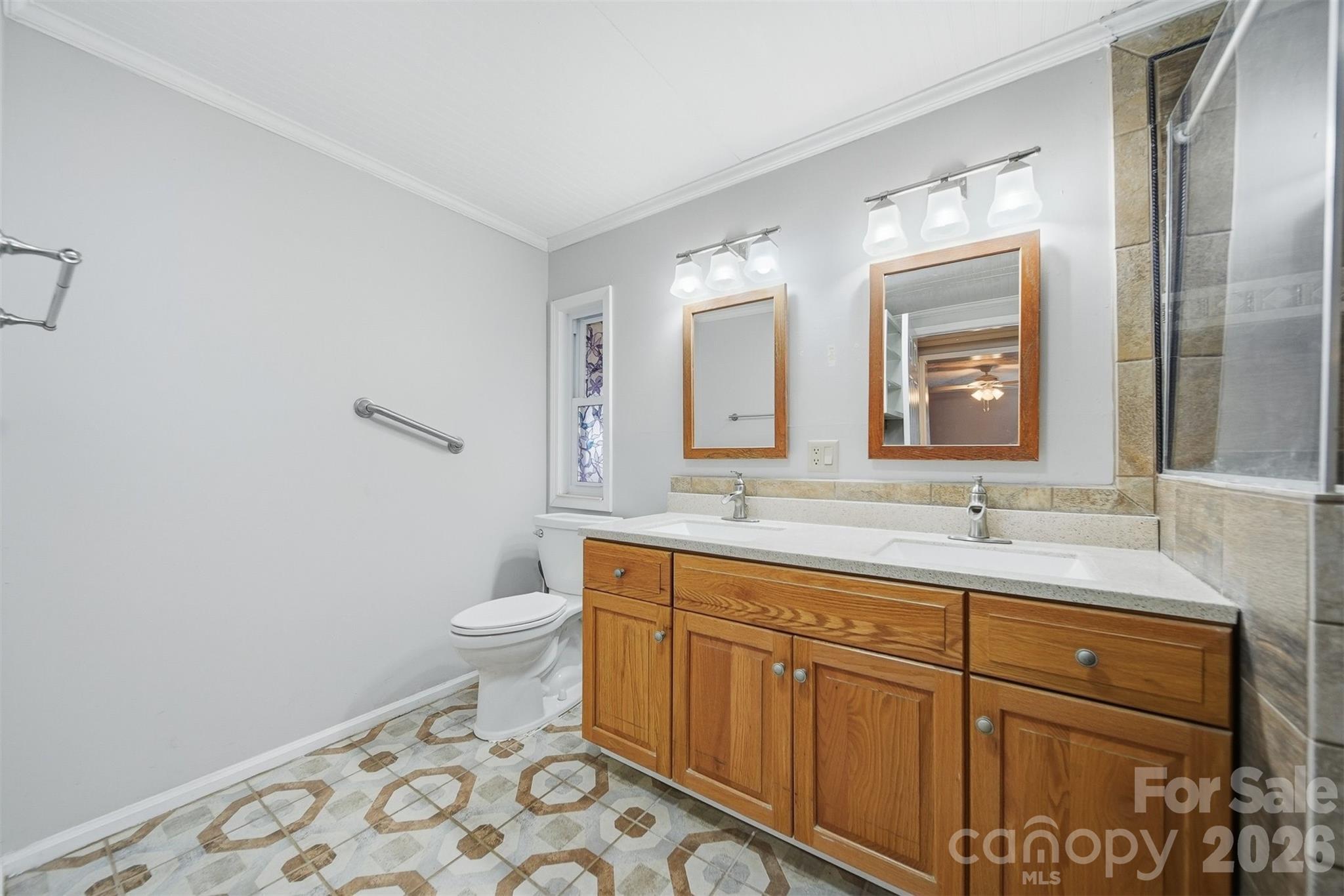 4915 Quartz Ridge Road Maiden, NC 28650 - Photo 17 of 38 a bathroom with a toilet sink and mirror