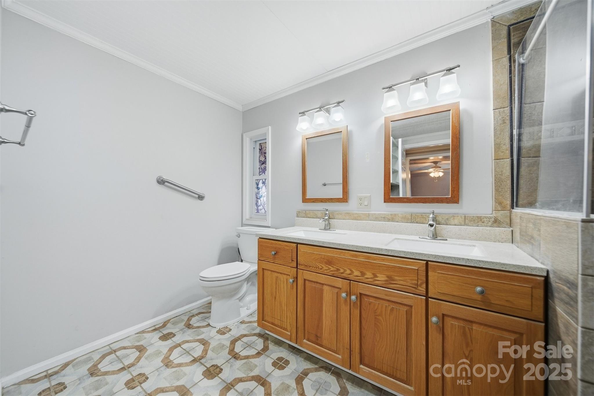 4915 Quartz Ridge Road Maiden, NC 28650 - Photo 17 of 38 a bathroom with a toilet sink and mirror