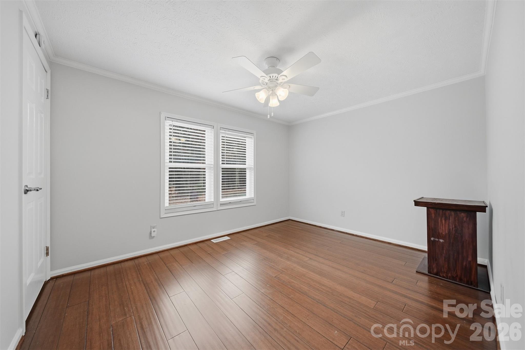 4915 Quartz Ridge Road Maiden, NC 28650 - Photo 25 of 38 an empty room with wooden floor and windows