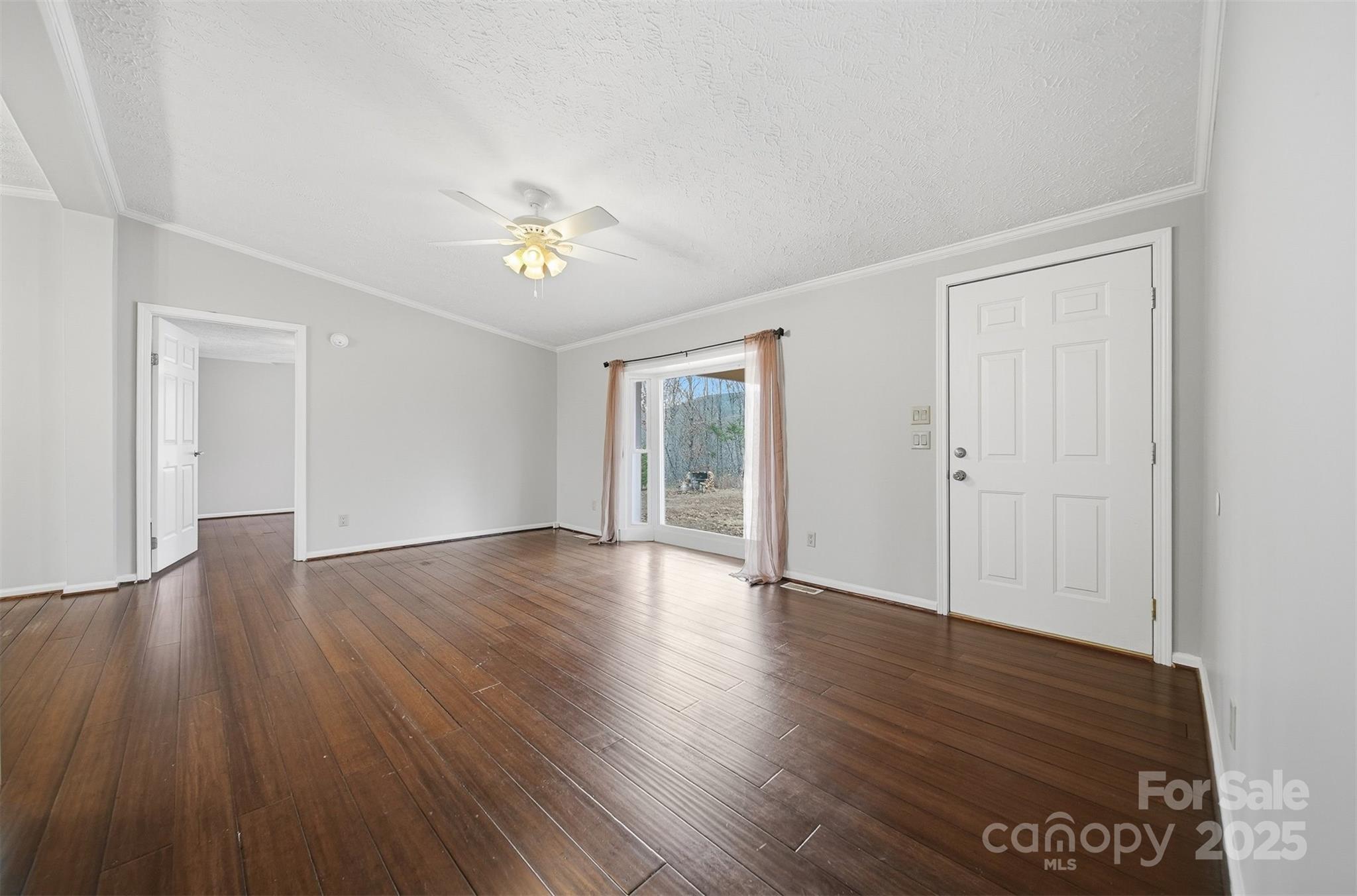 4915 Quartz Ridge Road Maiden, NC 28650 - Photo 5 of 38 a view of an empty room with wooden floor and a window