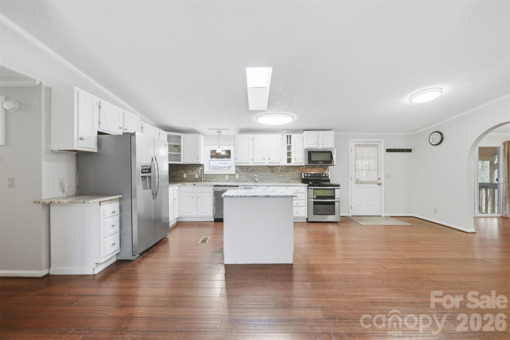 4915 Quartz Ridge Road Maiden, NC 28650 - Photo 5 of 38 a kitchen with stainless steel appliances a refrigerator and a stove top oven