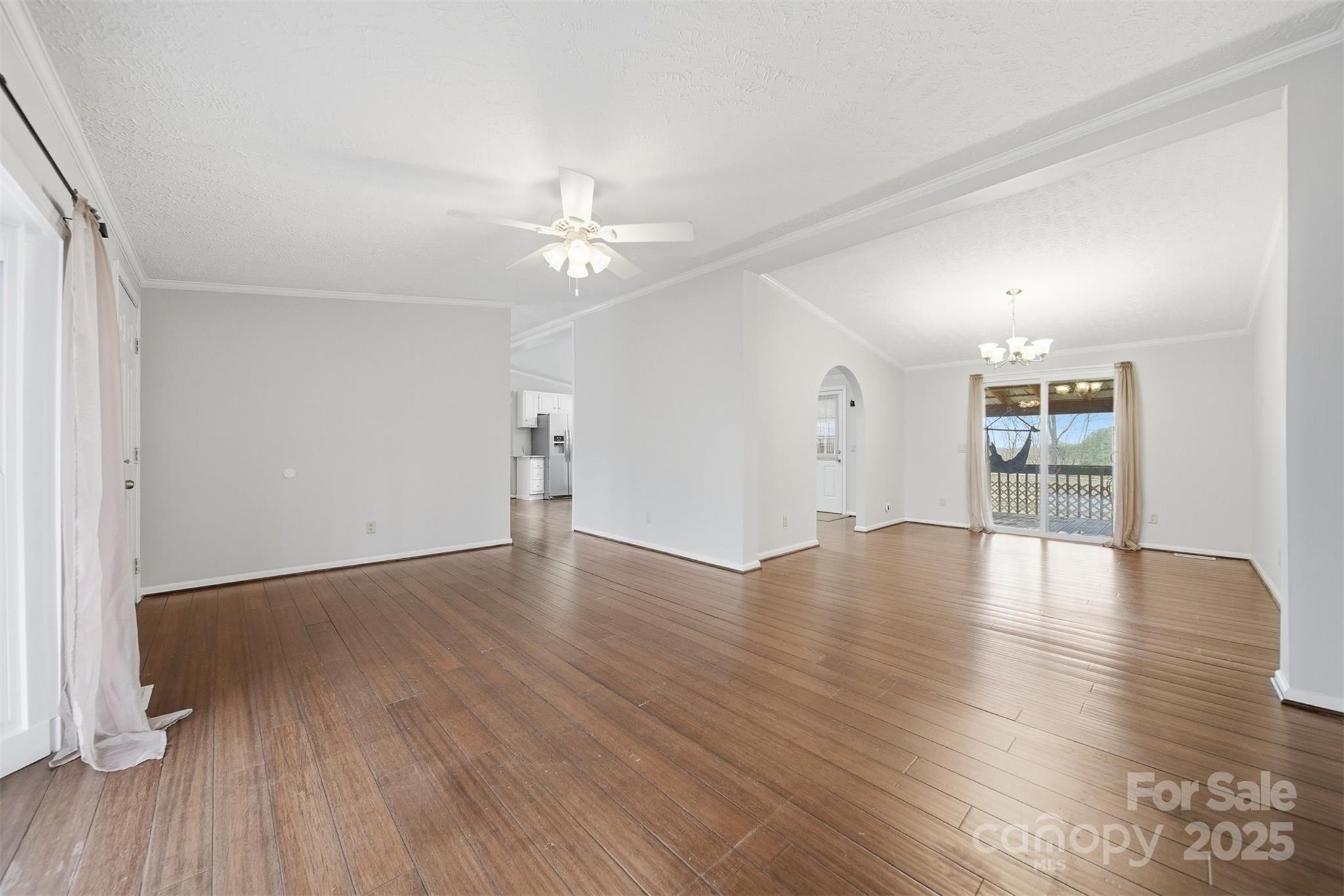 4915 Quartz Ridge Road Maiden, NC 28650 - Photo 6 of 38 an empty room with wooden floor and windows