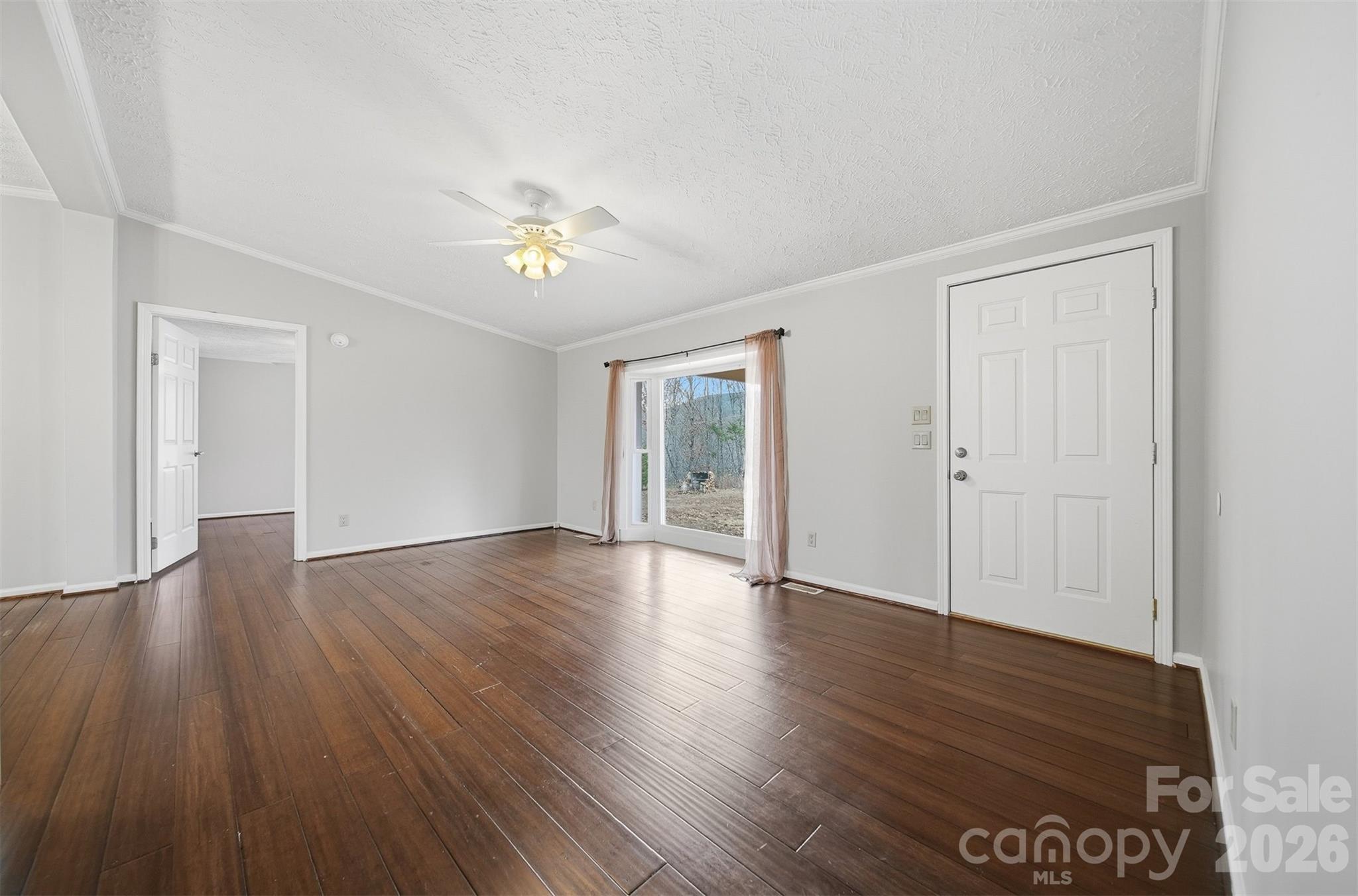 4915 Quartz Ridge Road Maiden, NC 28650 - Photo 9 of 38 a view of an empty room with wooden floor and a window
