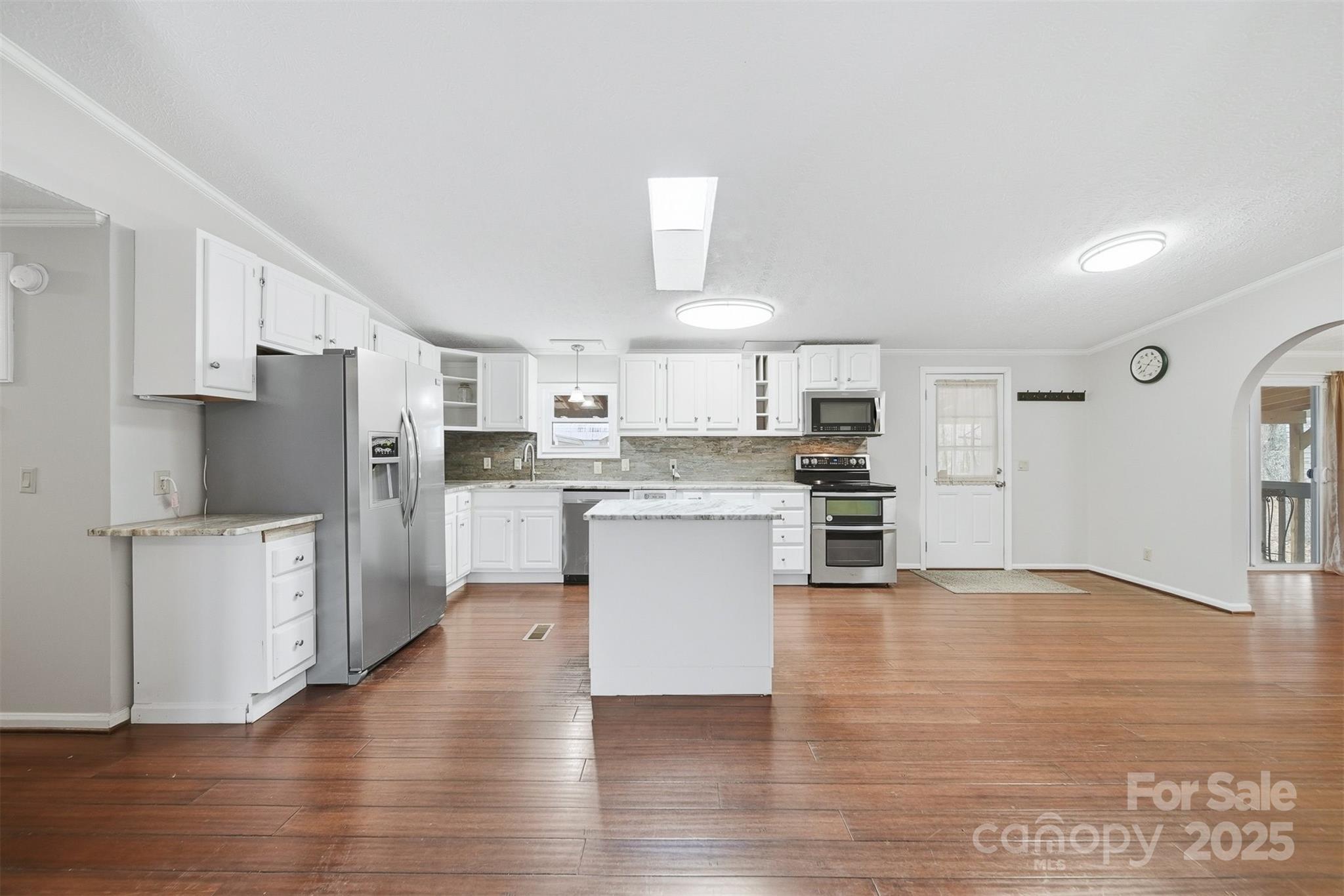 4915 Quartz Ridge Road Maiden, NC 28650 - Photo 9 of 38 a kitchen with stainless steel appliances a refrigerator and a stove top oven