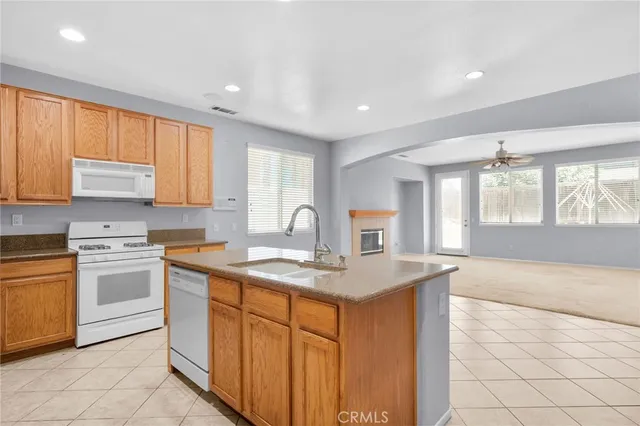 a kitchen with stainless steel appliances granite countertop a sink stove and cabinets