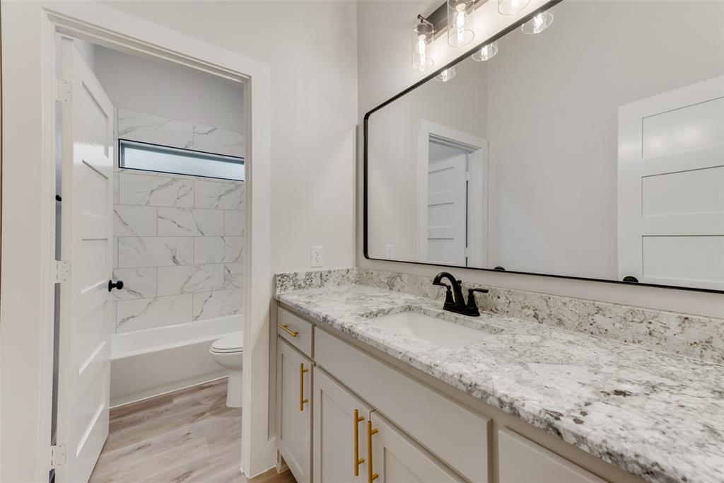 73 Dove Landing Rd Valley View Valley View, TX 76272 - Photo 23 of 34 Bathroom featuring vanity, light wood-type flooring, and bathtub / shower combination