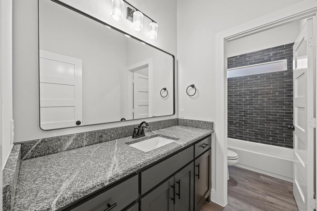 73 Dove Landing Rd Valley View Valley View, TX 76272 - Photo 23 of 30 Full bathroom with vanity, dark wood-type flooring, and shower / bathtub combination