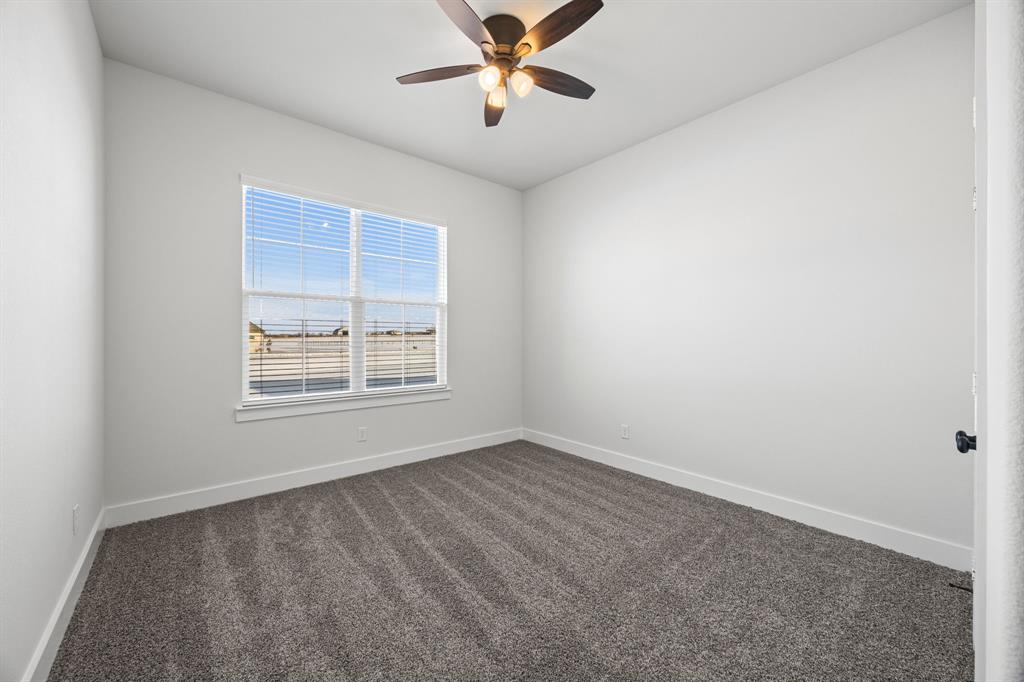 73 Dove Landing Rd Valley View Valley View, TX 76272 - Photo 24 of 30 Spare room featuring dark colored carpet and ceiling fan