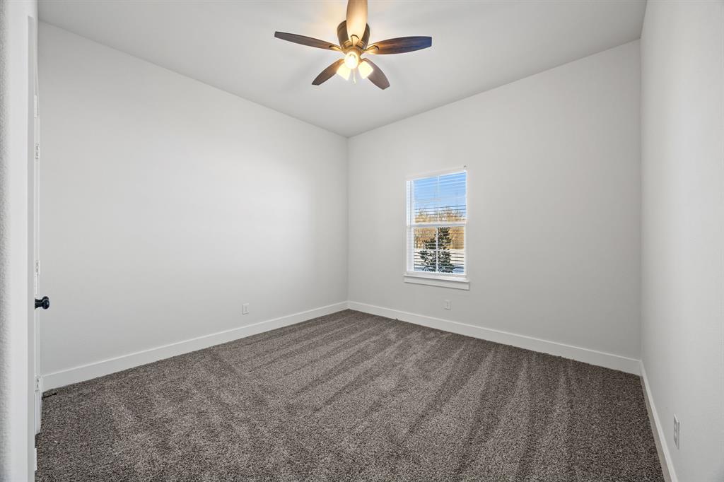 73 Dove Landing Rd Valley View Valley View, TX 76272 - Photo 25 of 30 Empty room featuring dark carpet and a ceiling fan
