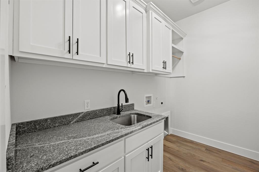 73 Dove Landing Rd Valley View Valley View, TX 76272 - Photo 26 of 30 Laundry area featuring light wood-style flooring, cabinet space, hookup for a washing machine, and hookup for an electric dryer