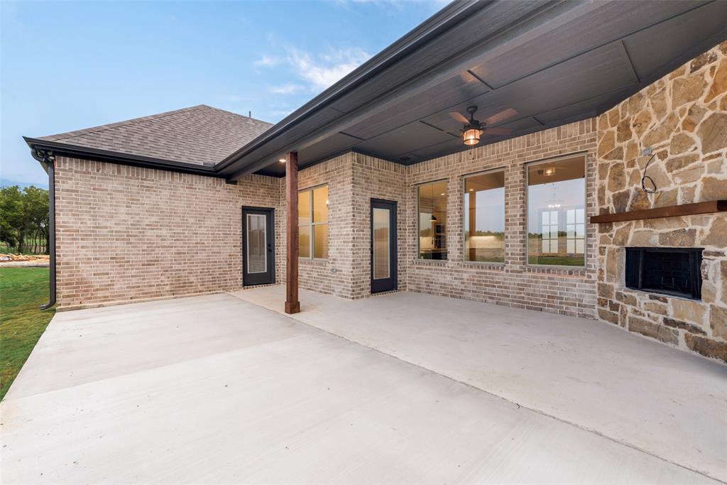 73 Dove Landing Rd Valley View Valley View, TX 76272 - Photo 30 of 34 View of patio featuring ceiling fan and an outdoor stone fireplace