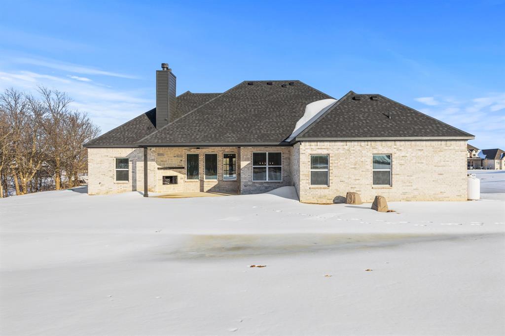 73 Dove Landing Rd Valley View Valley View, TX 76272 - Photo 29 of 30 Snow covered house with a patio, brick siding, and a chimney