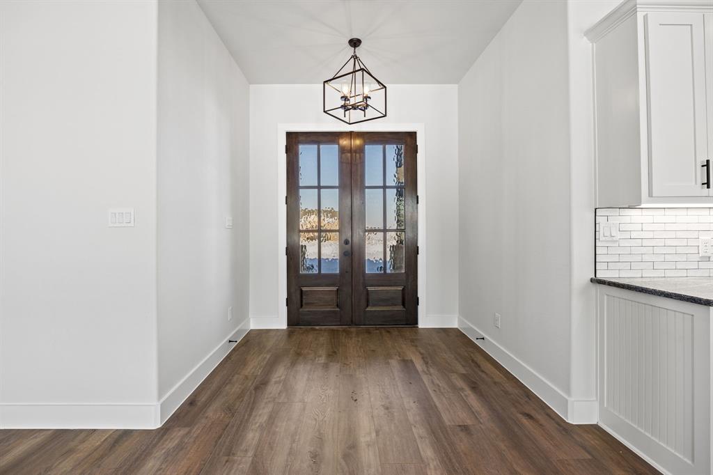 73 Dove Landing Rd Valley View Valley View, TX 76272 - Photo 3 of 30 Entrance foyer with dark wood-style flooring, french doors, and a chandelier