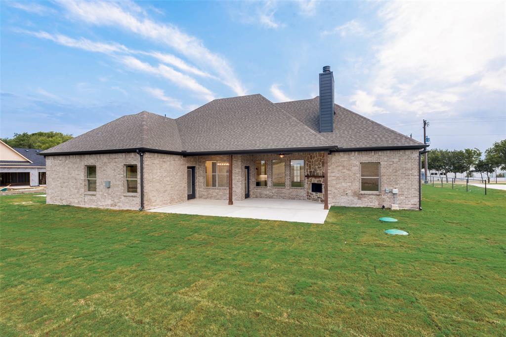 73 Dove Landing Rd Valley View Valley View, TX 76272 - Photo 32 of 34 Back of property with a lawn, a patio, brick siding, and a shingled roof
