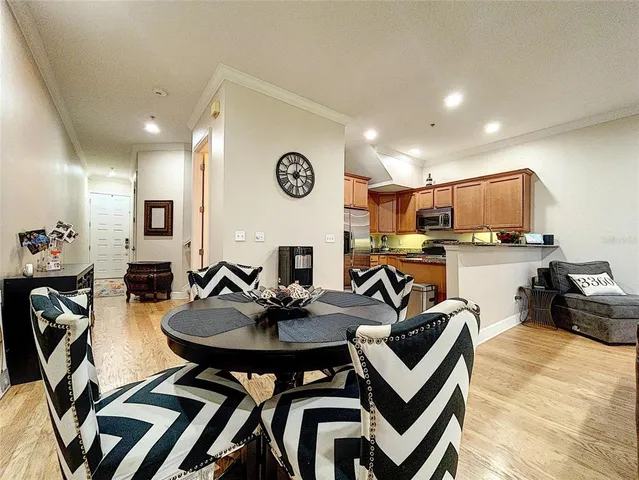 a view of a dining room with furniture and a kitchen