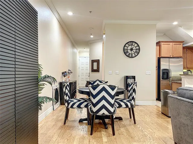 a dining room with furniture and wooden floor