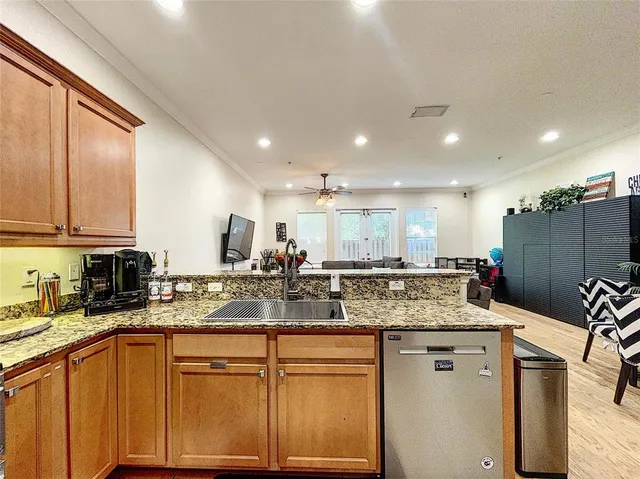 a kitchen with stainless steel appliances granite countertop a sink stove and cabinets